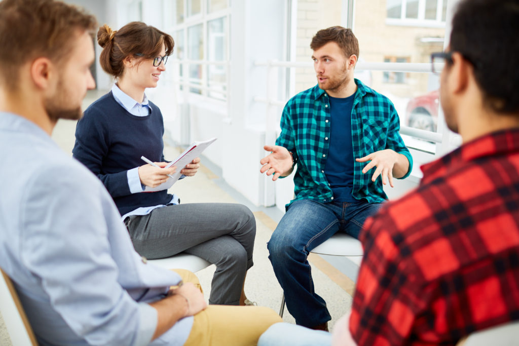 Circle of students practicing psychological therapy in group